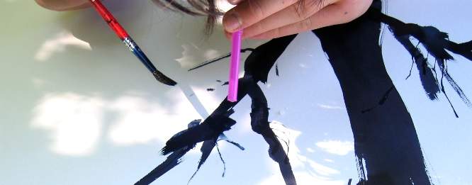 Blow through a straw to paint twigs.